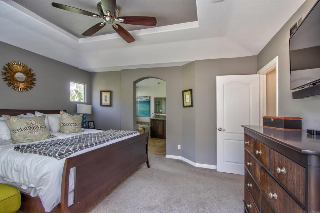 1684 Robin Place Carlsbad, CA 92011 - Photo 16 of 24 a bedroom with a bed and a chandelier