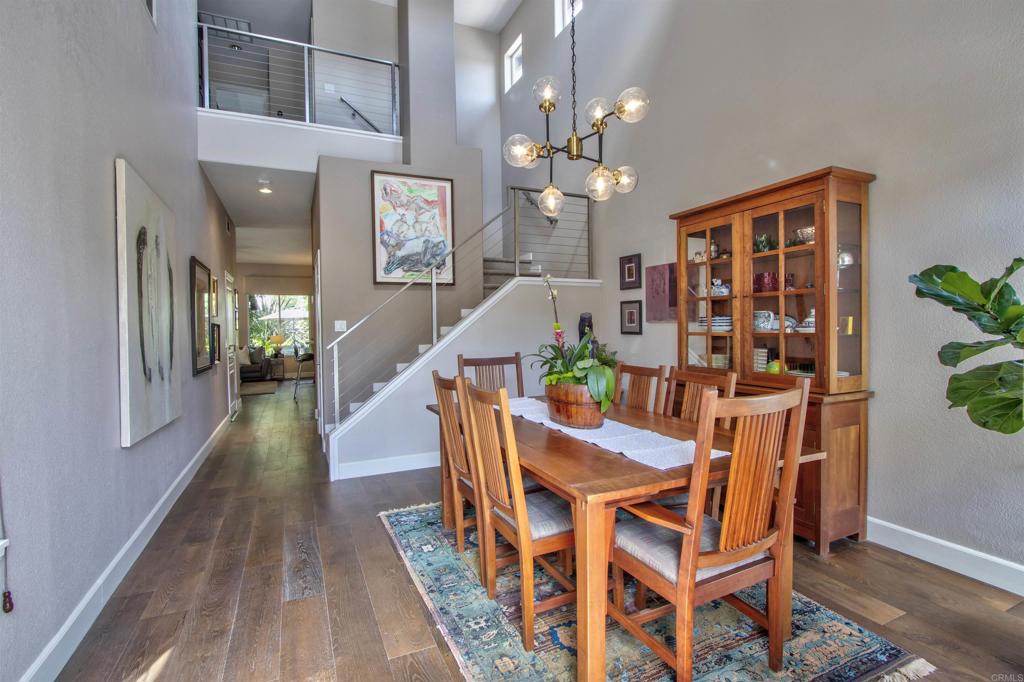 1684 Robin Place Carlsbad, CA 92011 - Photo 5 of 24 a dining room with wooden floor and chandelier
