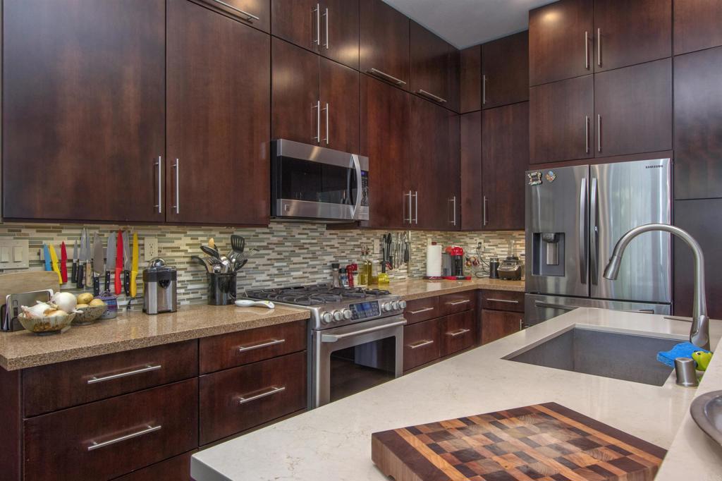 1684 Robin Place Carlsbad, CA 92011 - Photo 10 of 24 a kitchen with a sink a stove and cabinets