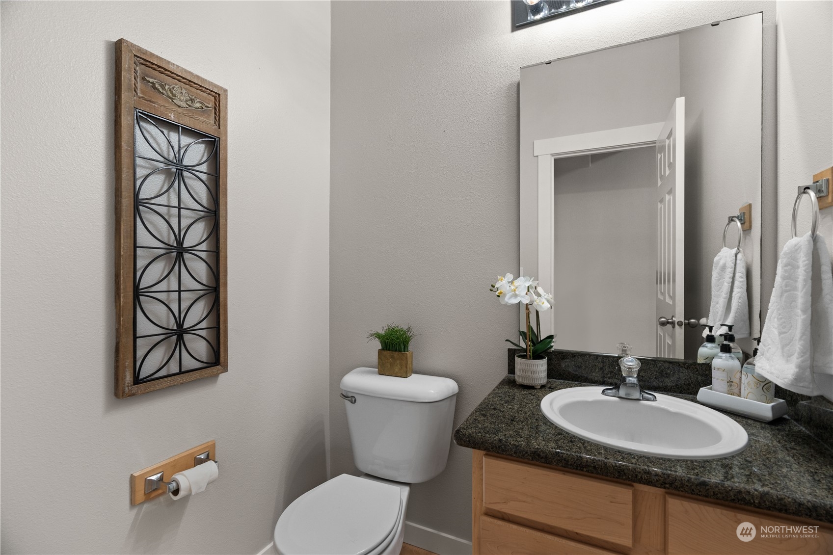 1012 186th Street Southeast Bothell, WA 98012 - Photo 16 of 40 a bathroom with a granite countertop toilet sink and mirror