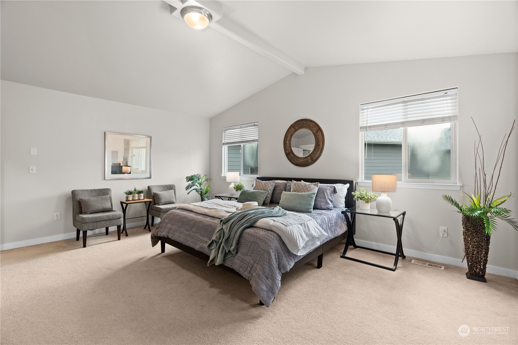 1012 186th Street Southeast Bothell, WA 98012 - Photo 18 of 40 a bedroom with a bed lamp and paintings on the wall