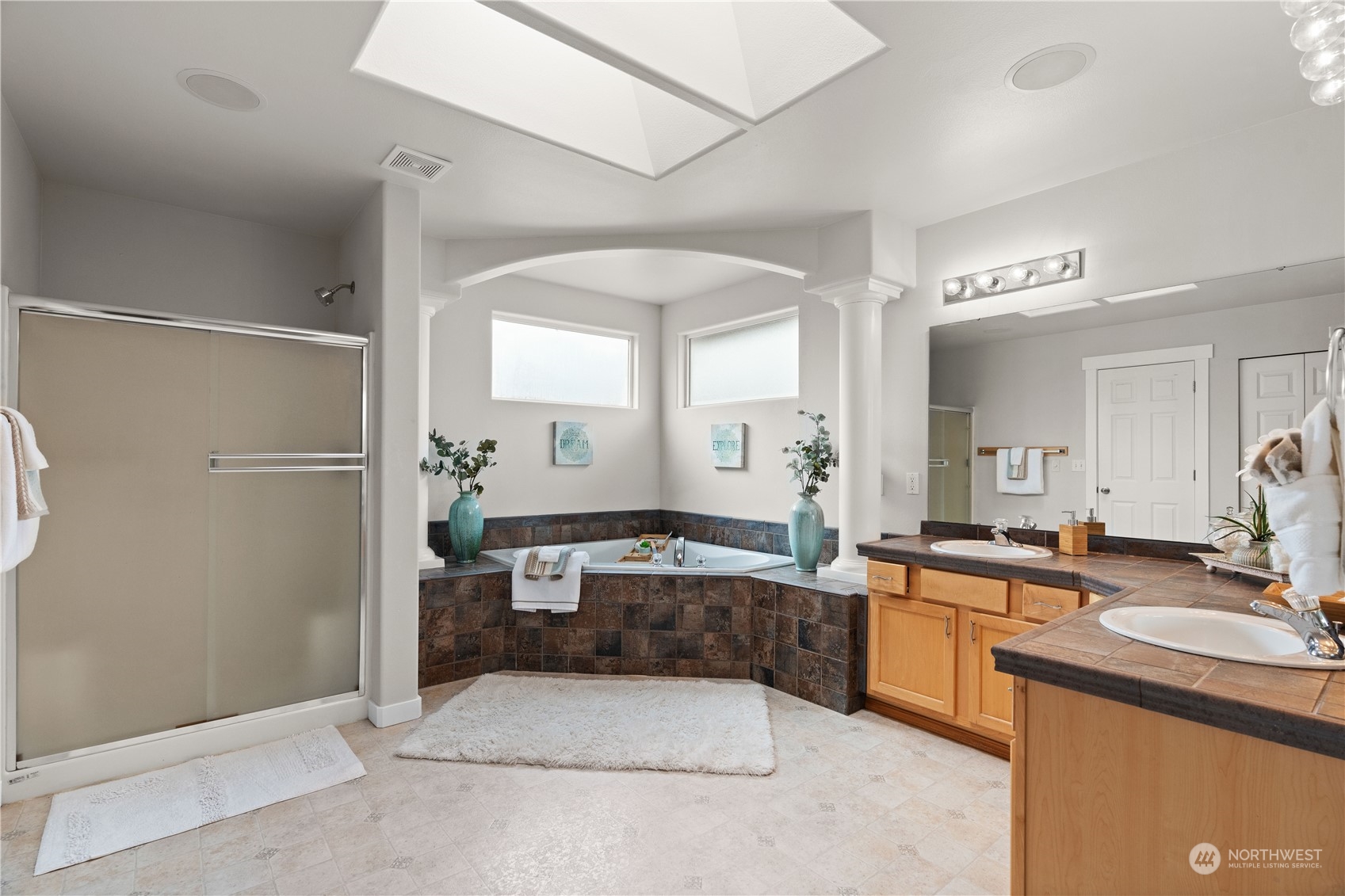 1012 186th Street Southeast Bothell, WA 98012 - Photo 30 of 40 a large bathroom with a double vanity sink a mirror and a shower