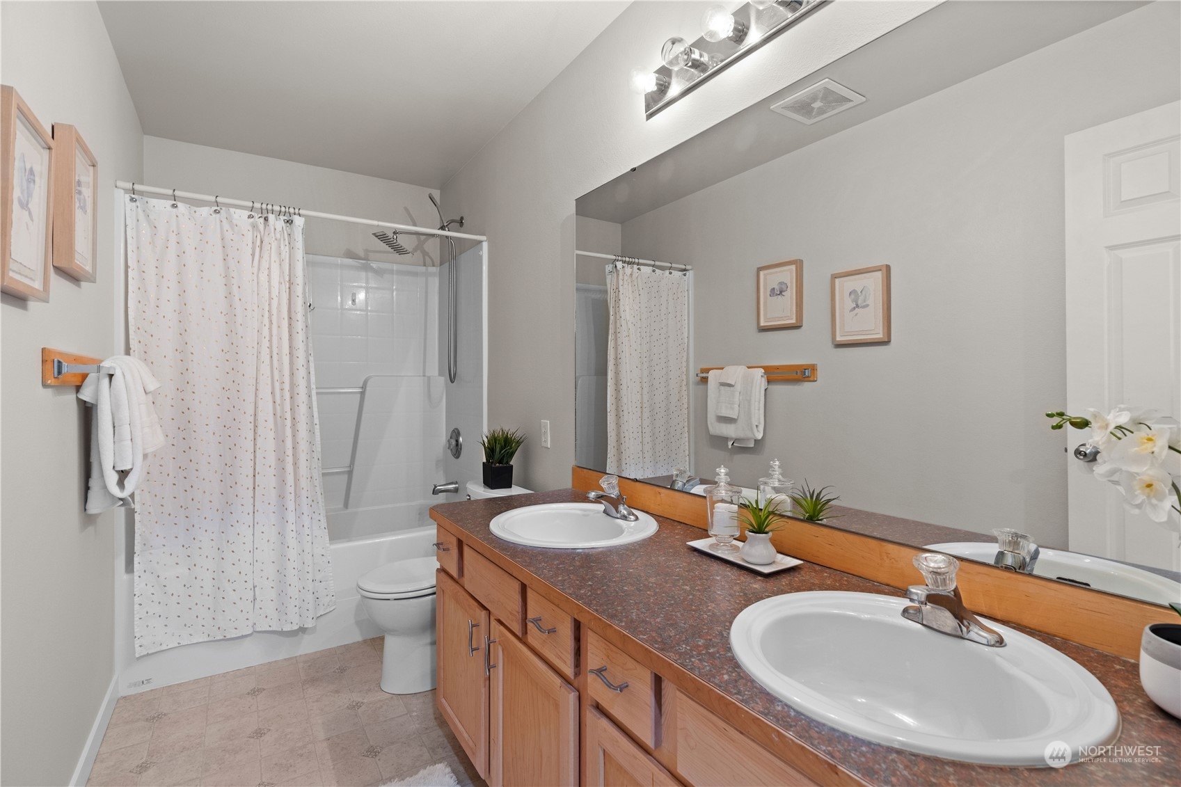 1012 186th Street Southeast Bothell, WA 98012 - Photo 33 of 40 a bathroom with double sink and a mirror