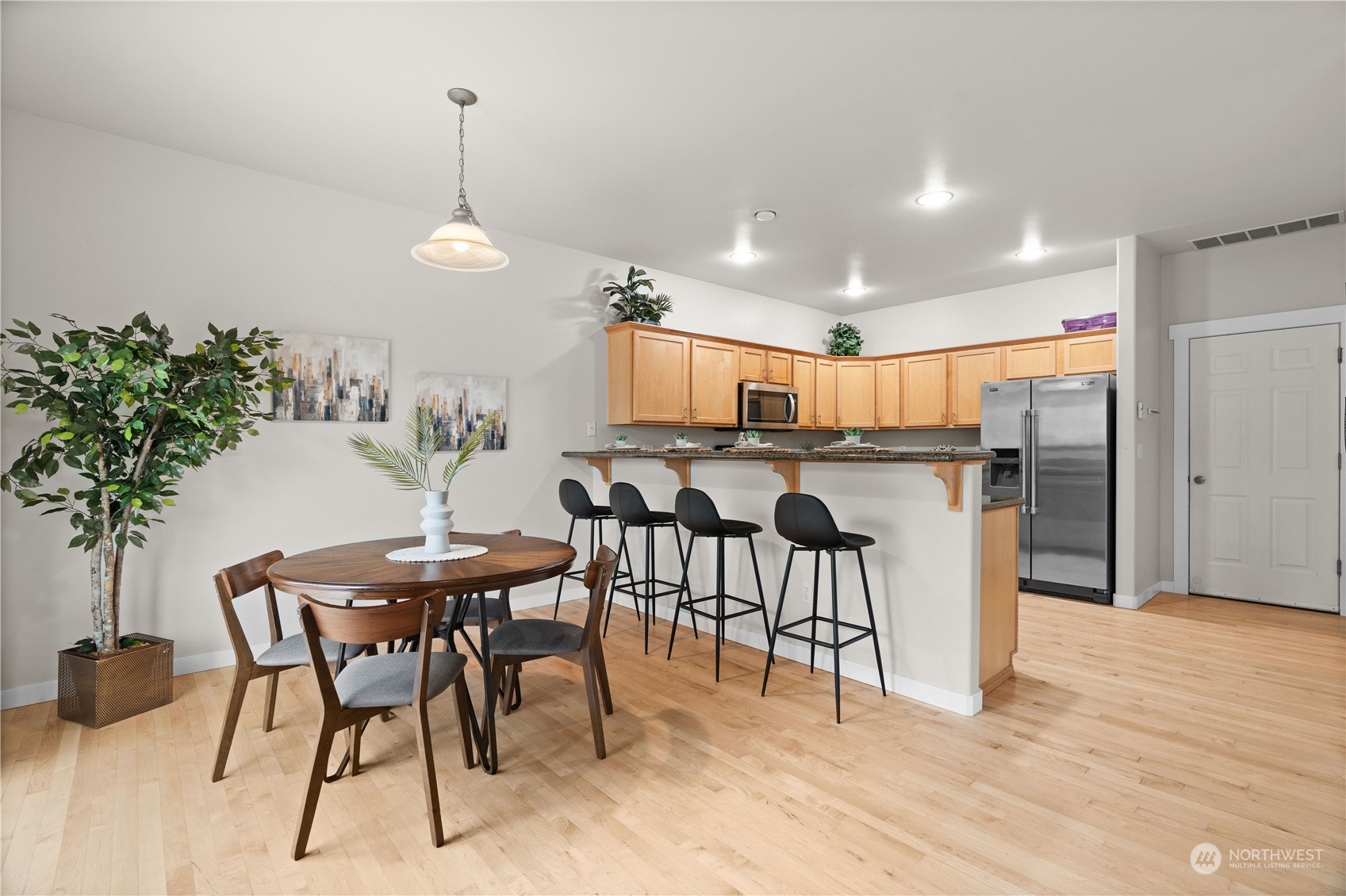 1012 186th Street Southeast Bothell, WA 98012 - Photo 7 of 40 a view of a dining room with furniture and wooden floor
