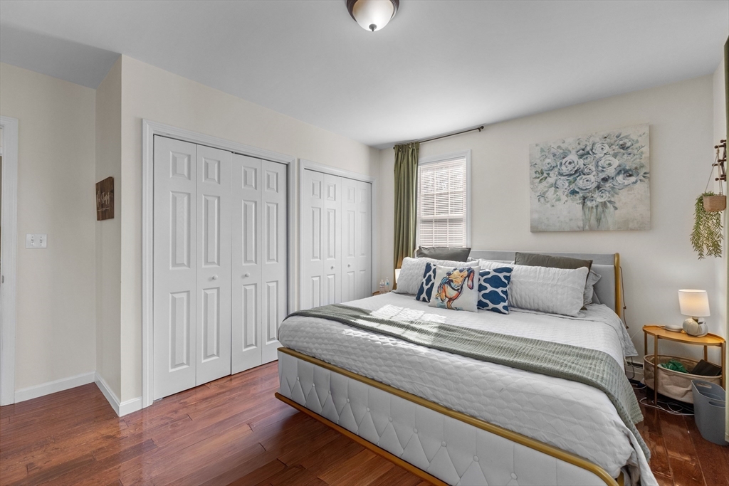 38 Brook Street Georgetown, MA 01833 - Photo 19 of 42 a bedroom with a large bed and a chandelier