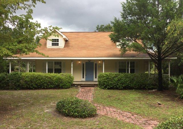 140 Mallet Bayou Road Freeport, FL 32439 - Photo 1 of 20 front view of a house with a yard