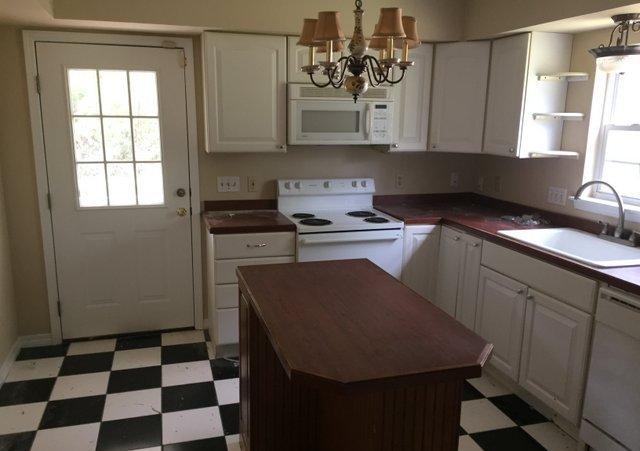 140 Mallet Bayou Road Freeport, FL 32439 - Photo 14 of 20 a kitchen with a sink a stove a refrigerator and cabinets