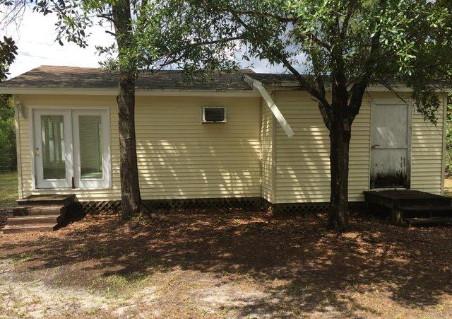 140 Mallet Bayou Road Freeport, FL 32439 - Photo 3 of 20 a view of a house with a yard