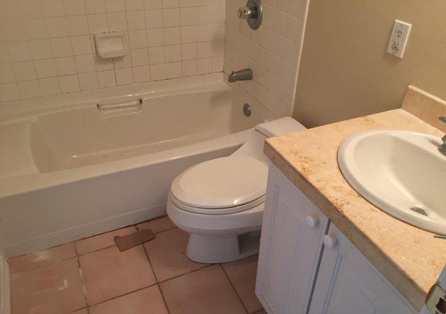 140 Mallet Bayou Road Freeport, FL 32439 - Photo 8 of 20 a bathroom with a granite countertop toilet and a bathtub