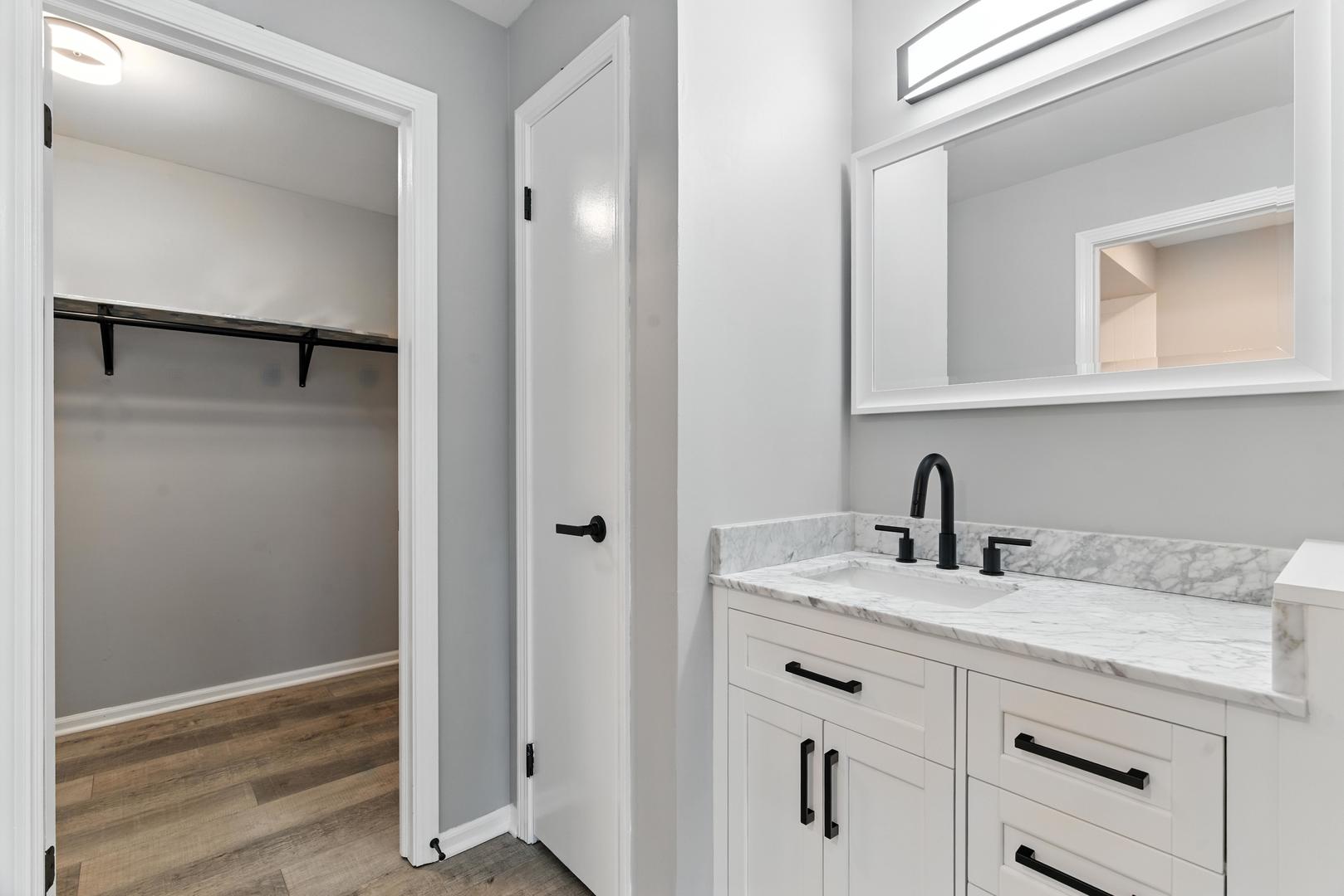 1415 Chartres Drive, Unit 1F Northbrook, IL 60062 - Photo 19 of 35 a bathroom with a sink and a mirror