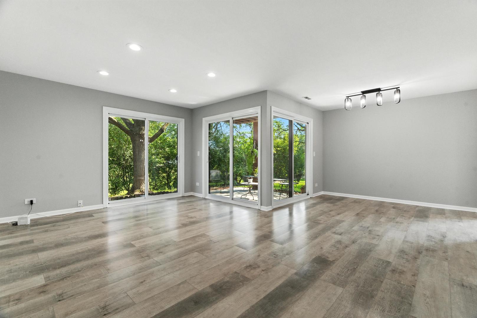 1415 Chartres Drive, Unit 1F Northbrook, IL 60062 - Photo 2 of 35 a view of an empty room with wooden floor and a window