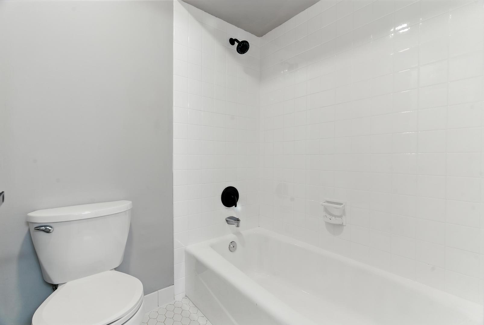 1415 Chartres Drive, Unit 1F Northbrook, IL 60062 - Photo 21 of 35 a white toilet sitting next to a bath tub