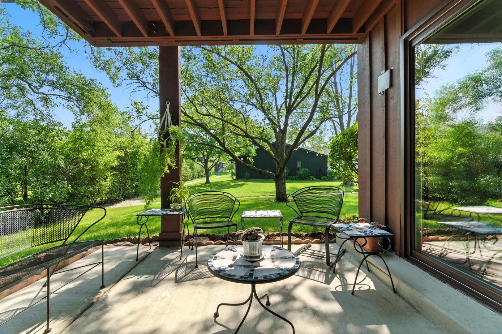 1415 Chartres Drive, Unit 1F Northbrook, IL 60062 - Photo 23 of 35 a view of a chairs and table in backyard of a house