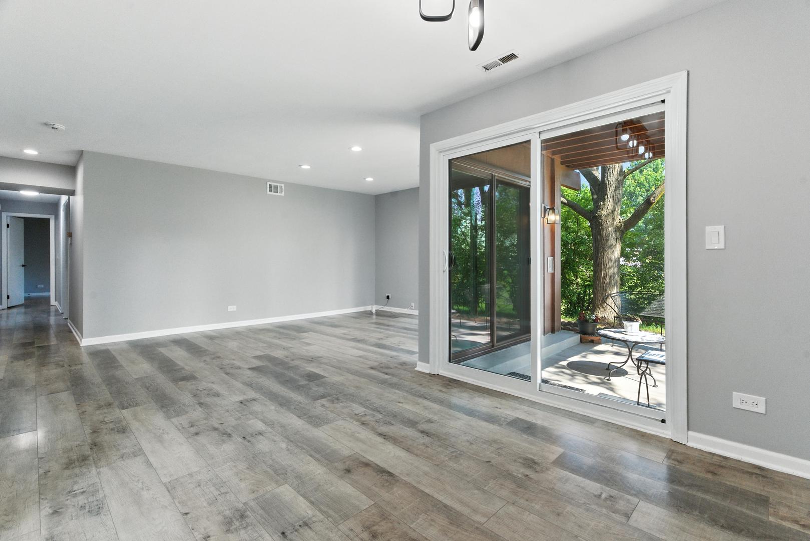 1415 Chartres Drive, Unit 1F Northbrook, IL 60062 - Photo 3 of 35 a view of a room with wooden floor and outdoor space