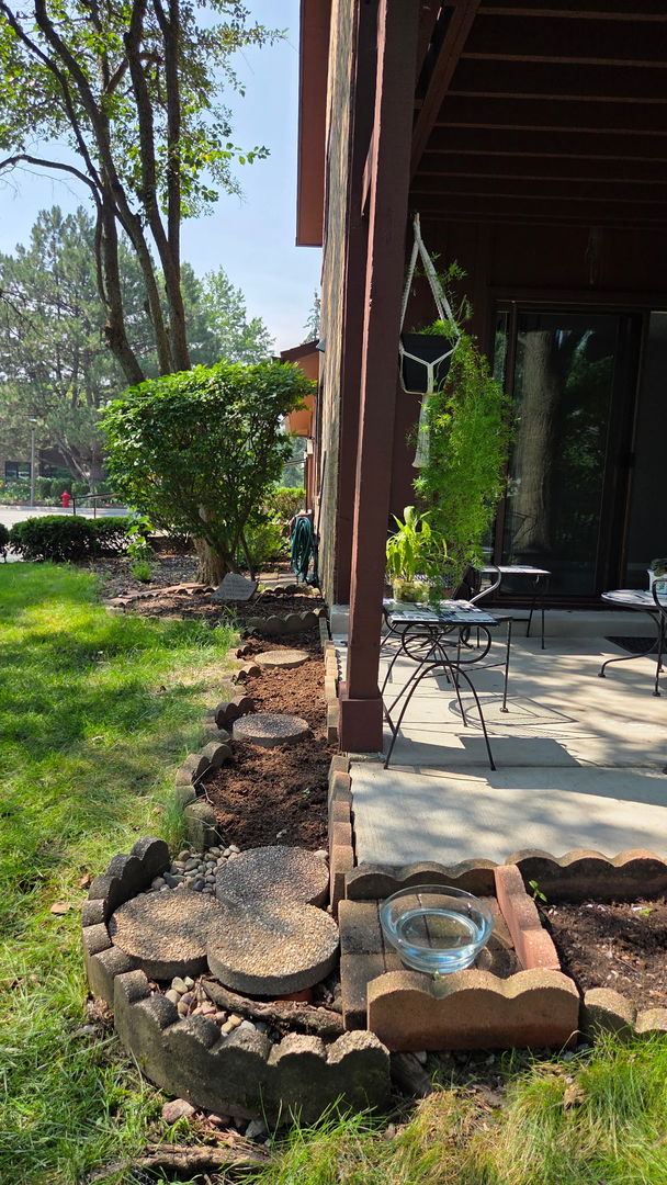 1415 Chartres Drive, Unit 1F Northbrook, IL 60062 - Photo 33 of 35 a view of a backyard with plants and a patio
