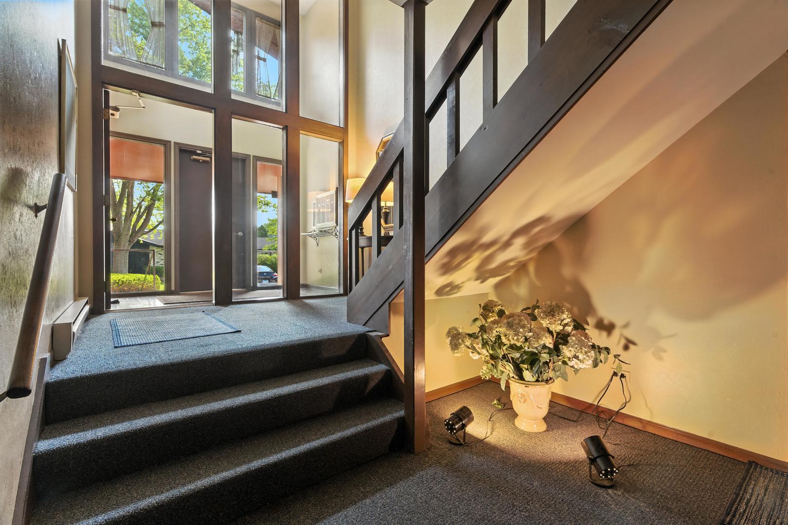 1415 Chartres Drive, Unit 1F Northbrook, IL 60062 - Photo 34 of 35 a view of staircase with a rug and a window