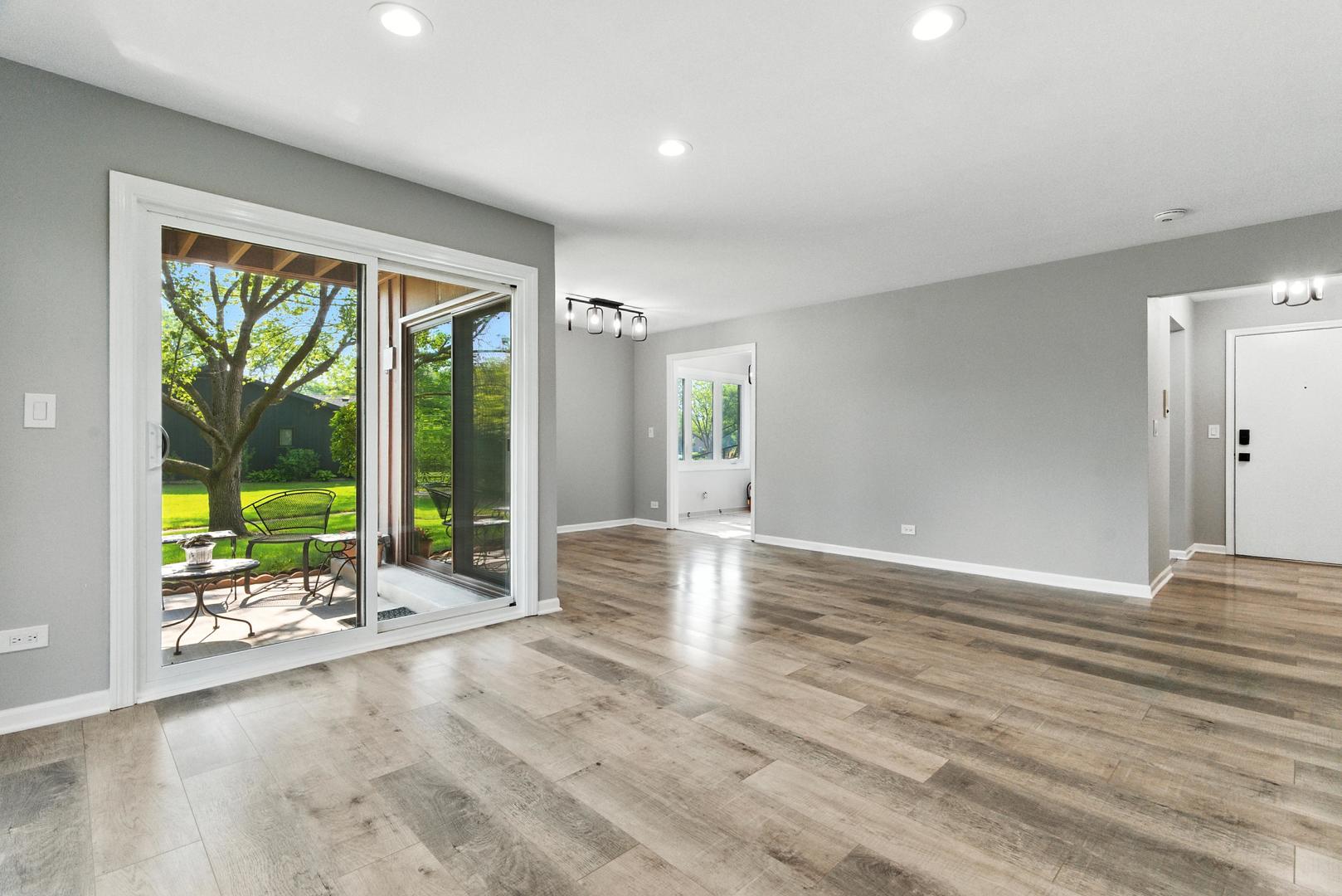1415 Chartres Drive, Unit 1F Northbrook, IL 60062 - Photo 4 of 35 a view of an empty room with wooden floor and a window