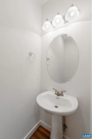 a bathroom with a sink a mirror and vanity