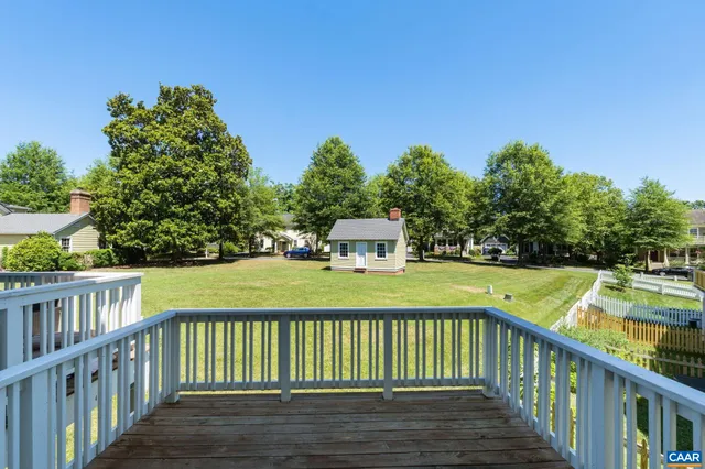 a view of a wooden deck and a yard