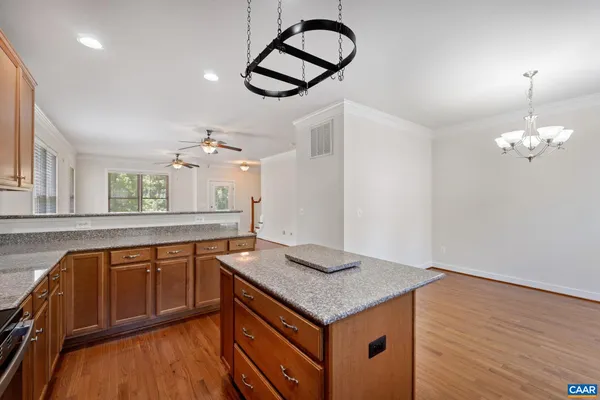 a kitchen with a sink a counter space and wooden floor