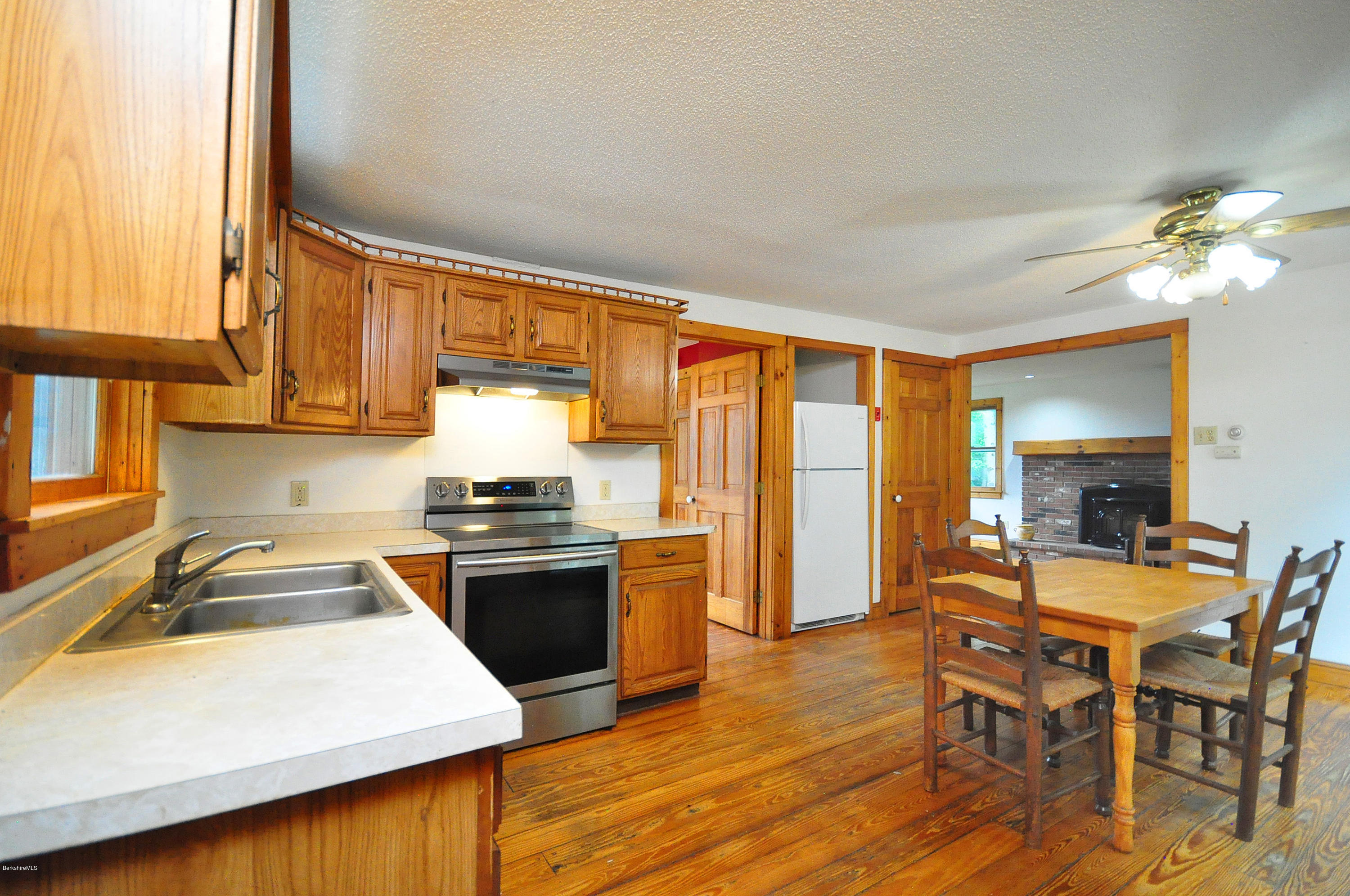 6 Johnnycake Hill Road Chester, MA 01011 - Photo 19 of 43 a kitchen with stainless steel appliances granite countertop a stove a sink dishwasher and a refrigerator with wooden floor