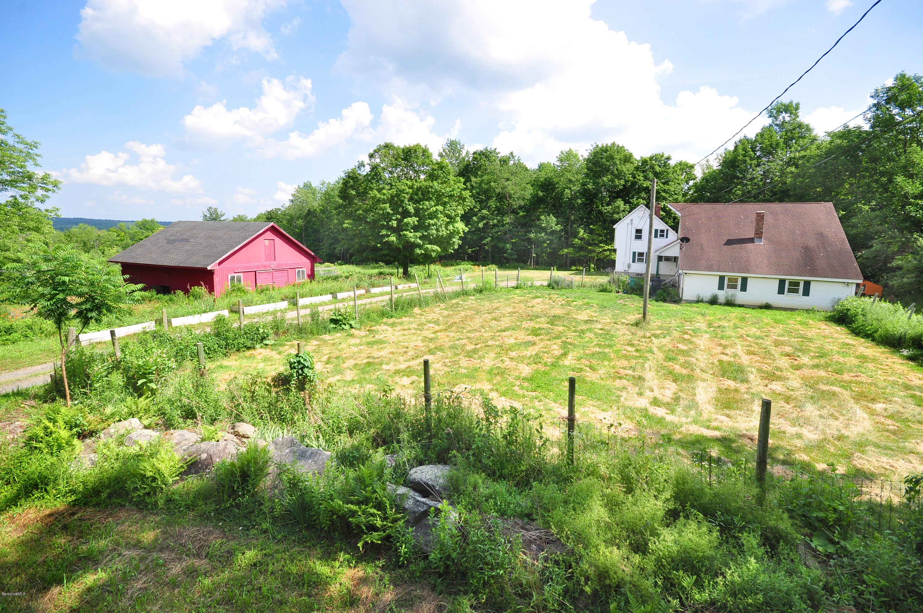 6 Johnnycake Hill Road Chester, MA 01011 - Photo 3 of 43 a backyard of a house with yard and outdoor seating