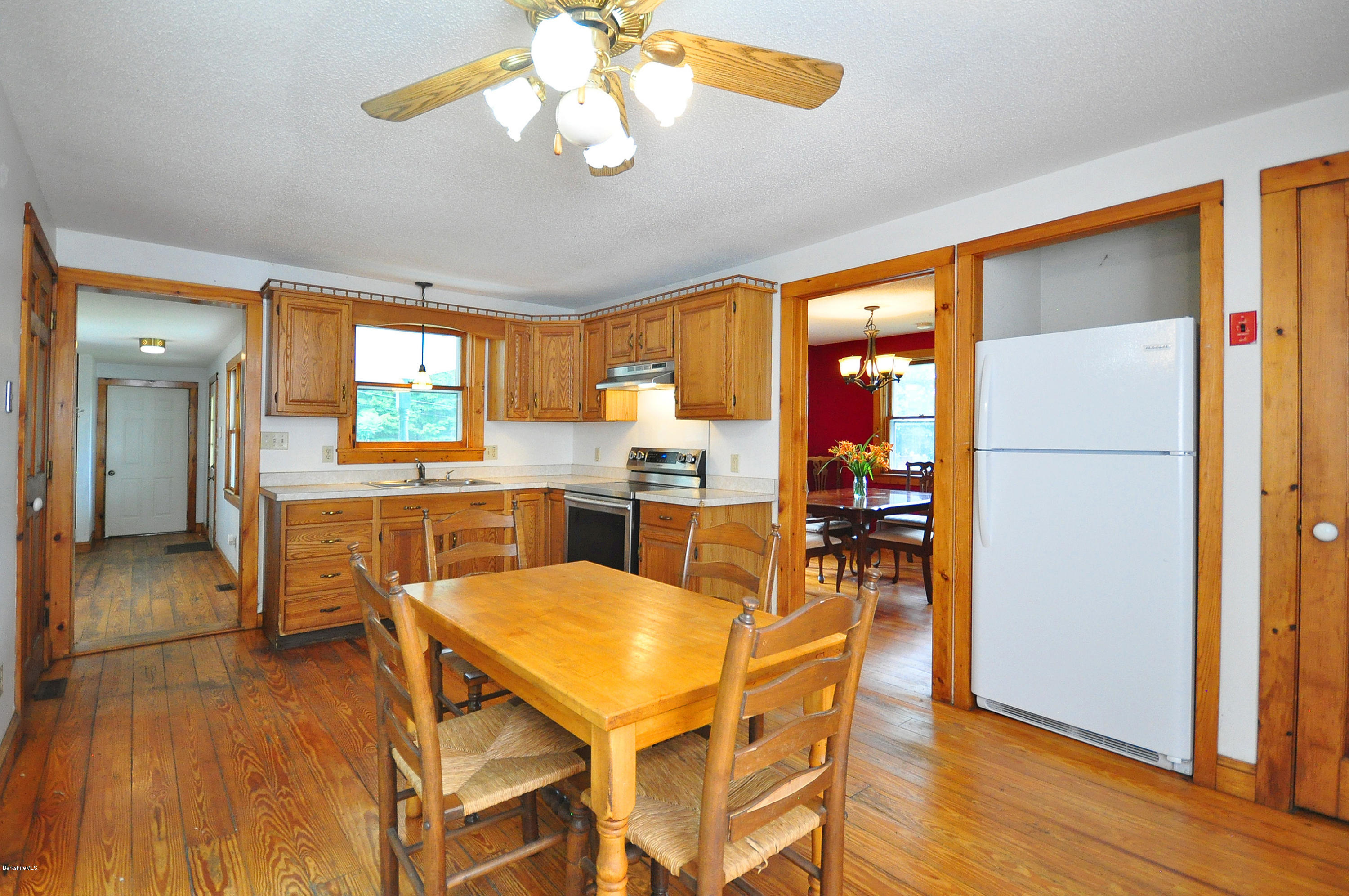 6 Johnnycake Hill Road Chester, MA 01011 - Photo 21 of 43 a view of a dining room with furniture a chandelier and wooden floor