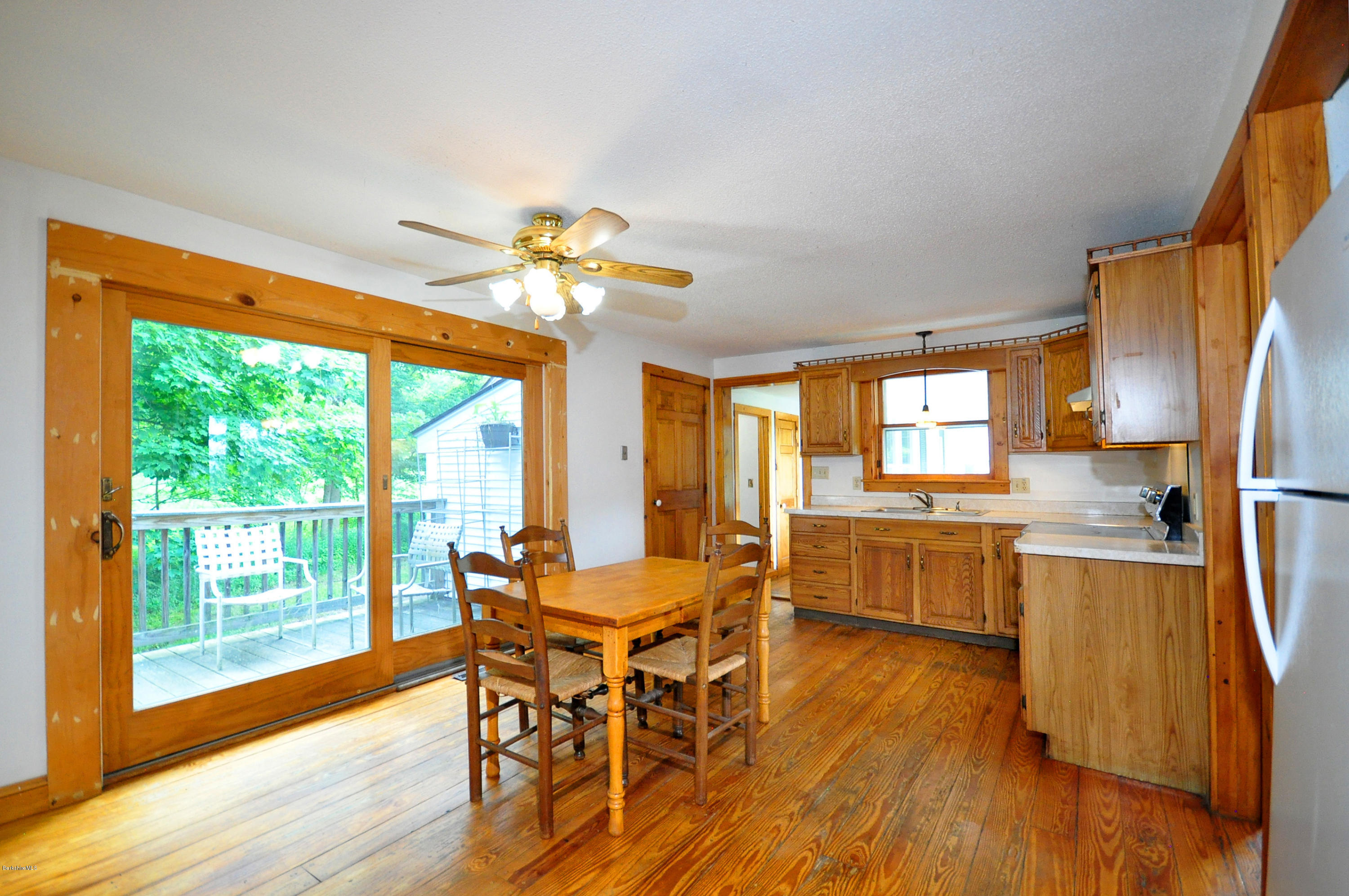 6 Johnnycake Hill Road Chester, MA 01011 - Photo 22 of 43 a view of a dining room with furniture a chandelier and wooden floor