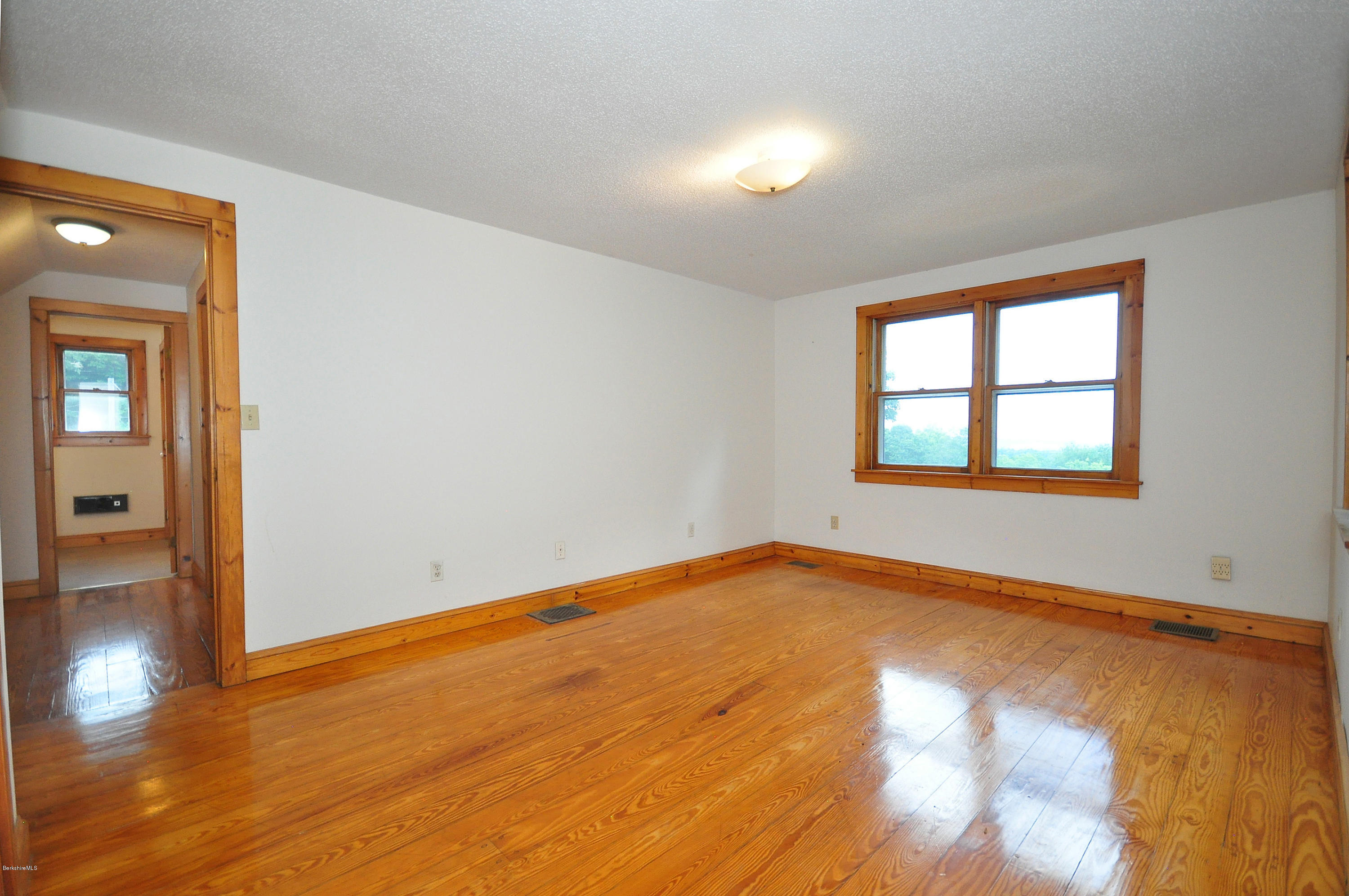 6 Johnnycake Hill Road Chester, MA 01011 - Photo 35 of 43 an empty room with wooden floor and windows