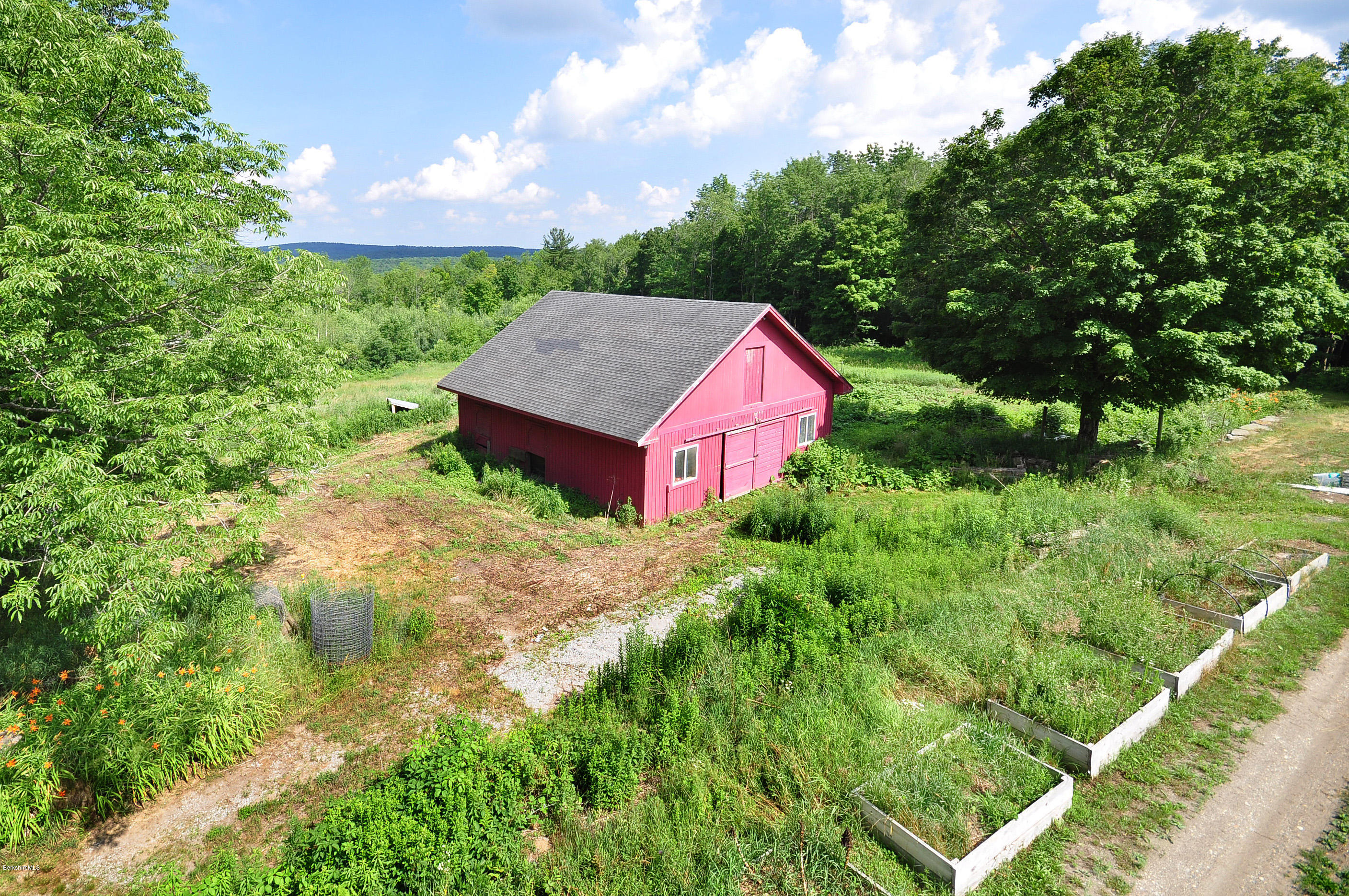 6 Johnnycake Hill Road Chester, MA 01011 - Photo 8 of 43 a aerial view of a house with a yard table and chairs