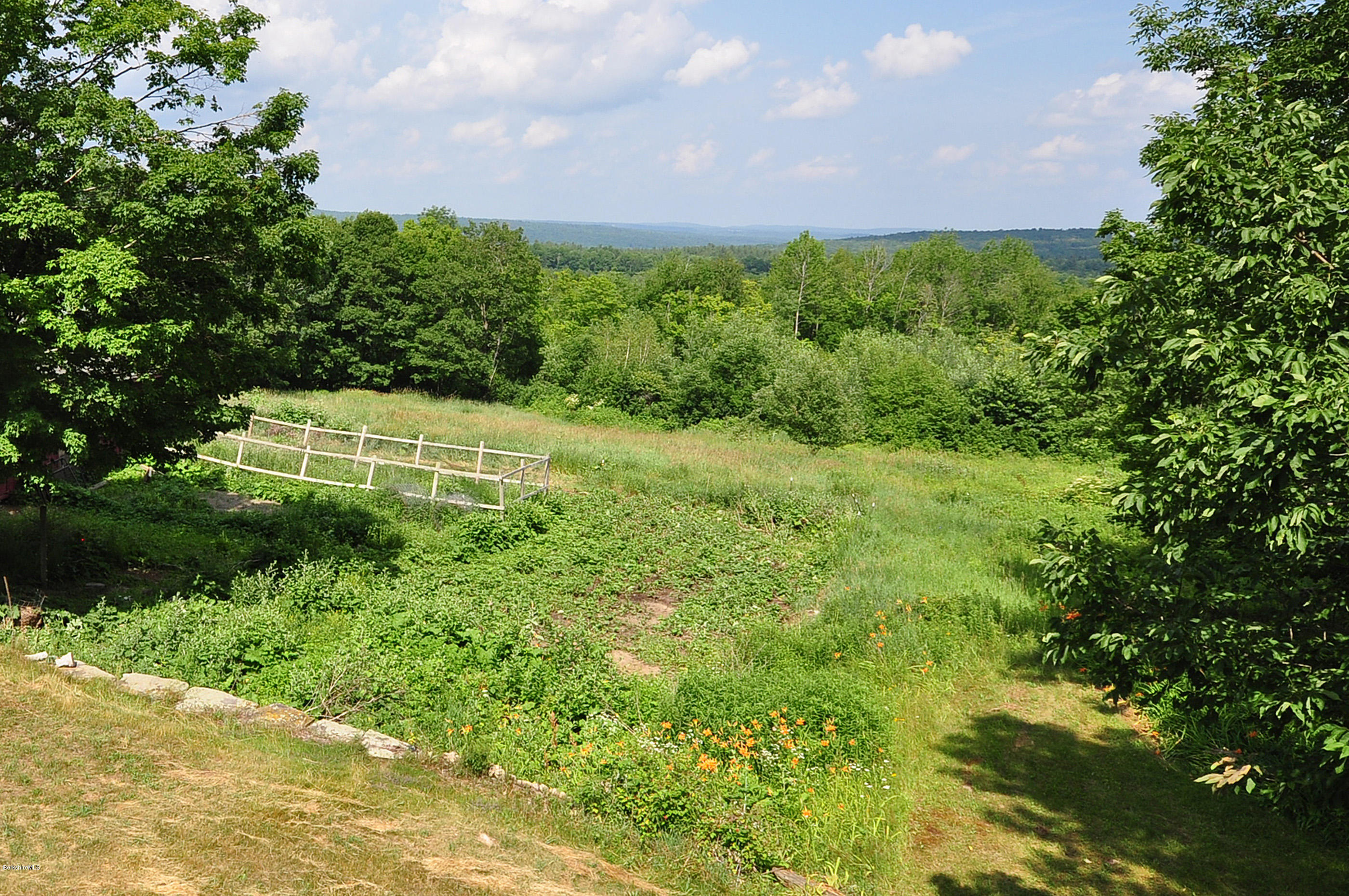 6 Johnnycake Hill Road Chester, MA 01011 - Photo 9 of 43 a view of a garden with a building in the background
