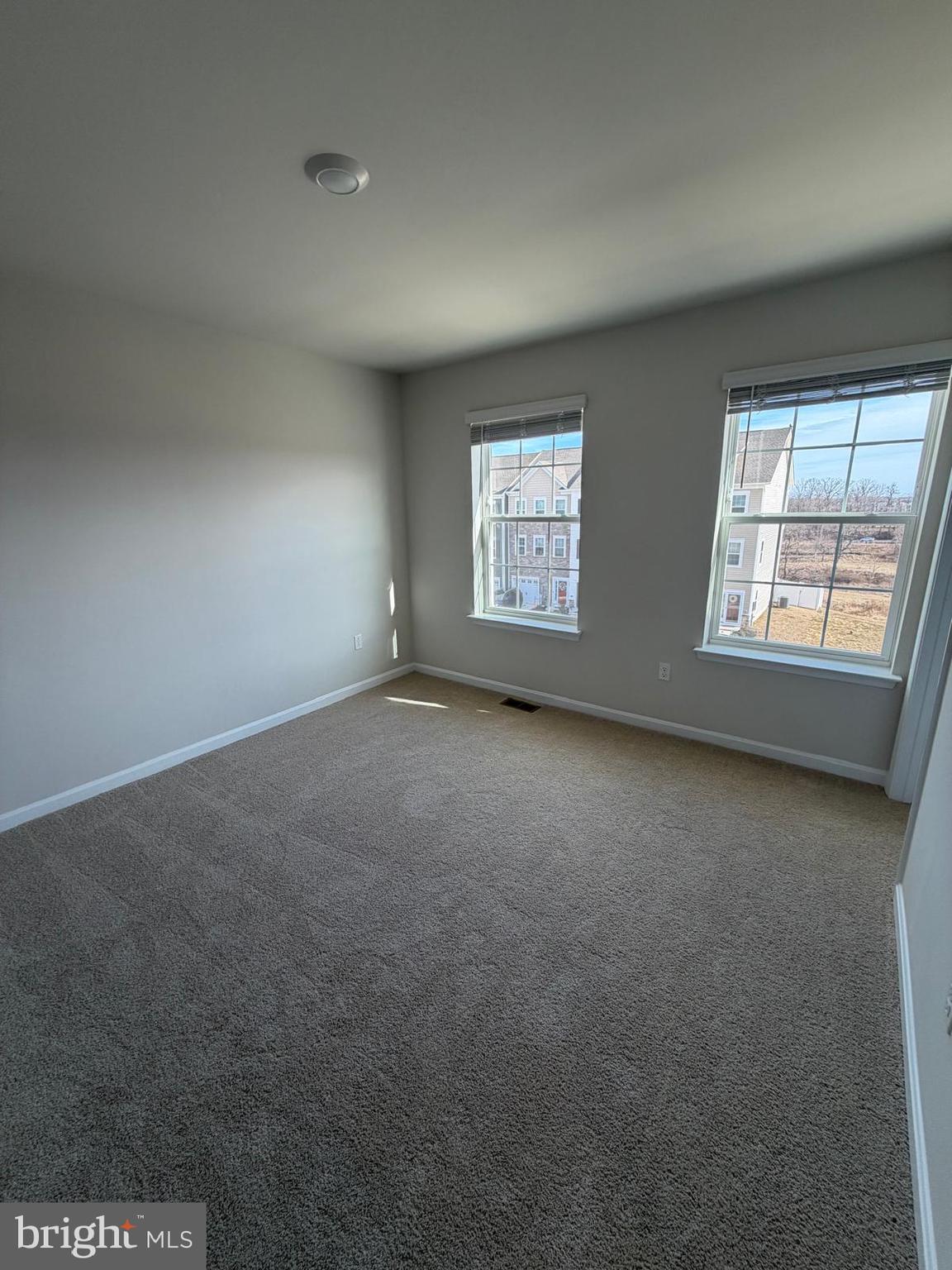 5036 Silver Oak Drive Baltimore, MD 21237 - Photo 5 of 7 an empty room with windows
