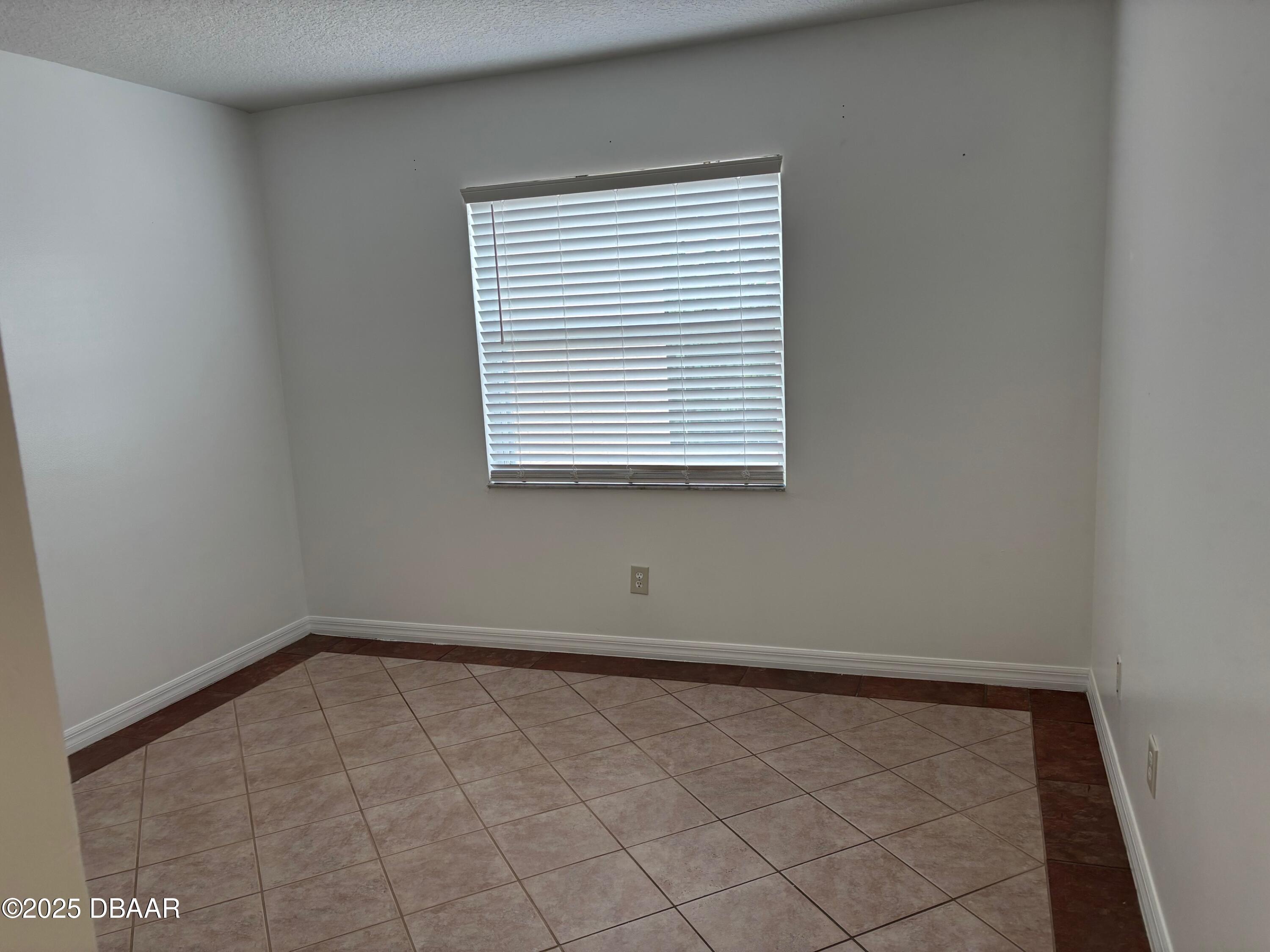 3724 South Atlantic Avenue, Unit 4 Daytona Beach, FL 32118 - Photo 7 of 10 an empty room with a window
