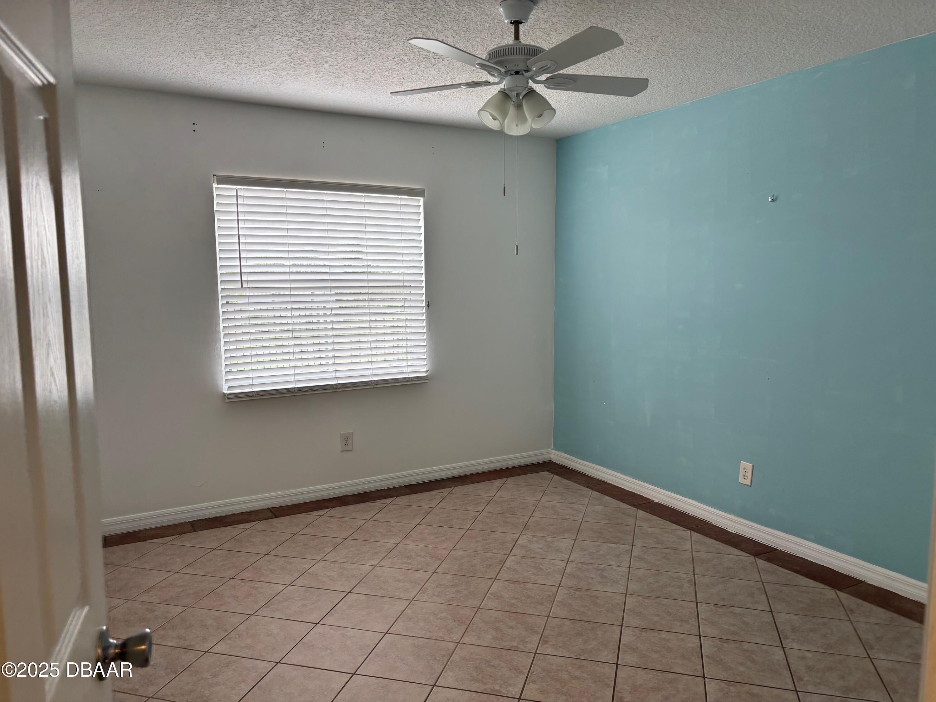 3724 South Atlantic Avenue, Unit 4 Daytona Beach, FL 32118 - Photo 9 of 10 a view of an empty room with a window