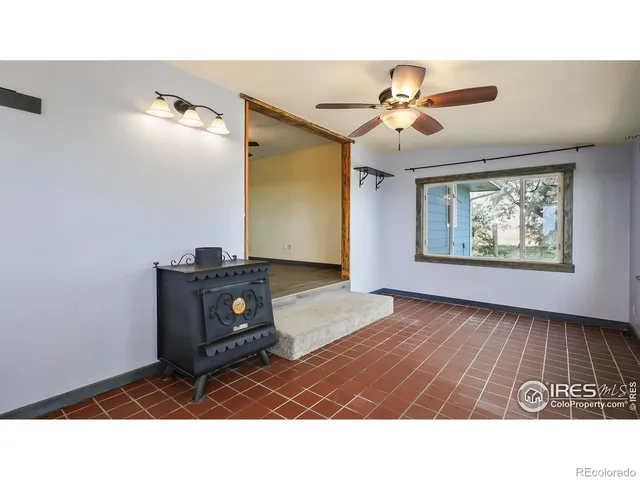 a living room with furniture and a ceiling fan