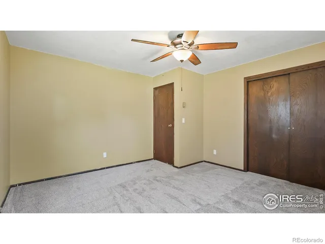 a picture of a room with a ceiling fan