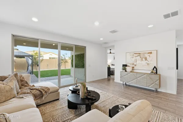 a kitchen with stainless steel appliances granite countertop a sink a stove and a wooden floors