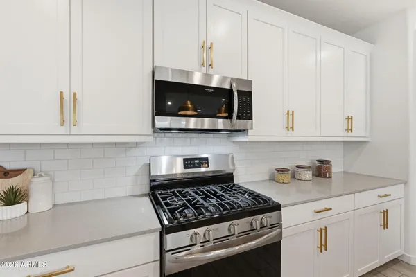 a kitchen with counter space appliances and living room