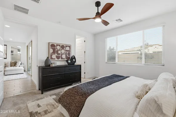 a bedroom with a bed and a window