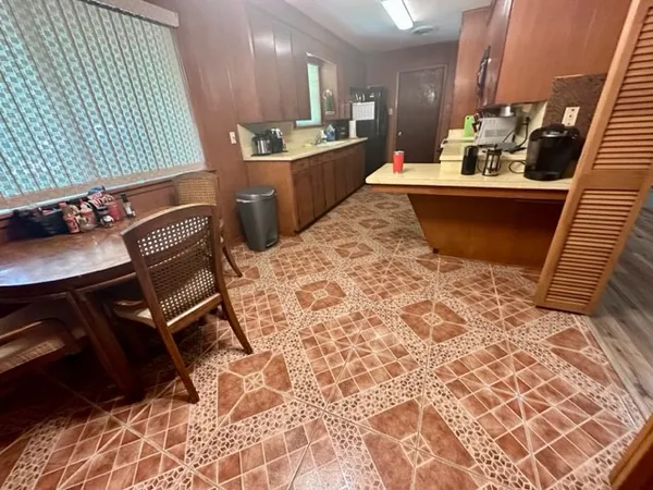 a room with table chairs and wooden floor