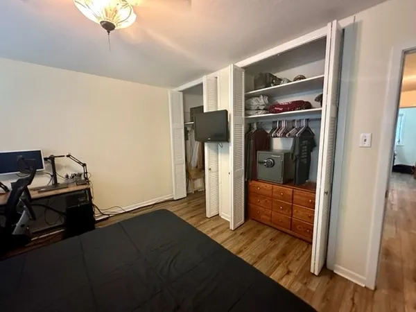 a bedroom with a bed and wooden floor