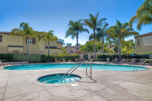 a view of a backyard with swimming pool