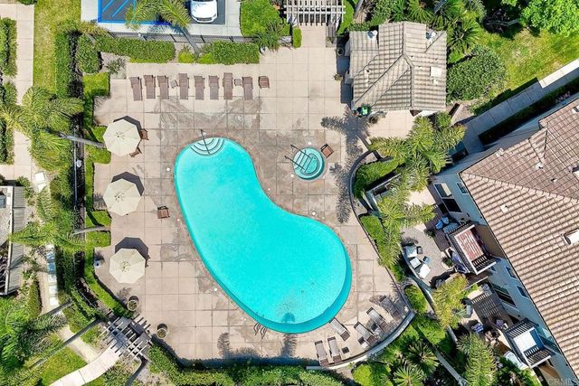 a view of swimming pool with outdoor seating and yard in the back