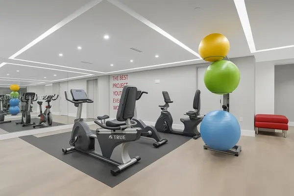 a room with gym equipment and air hockey table