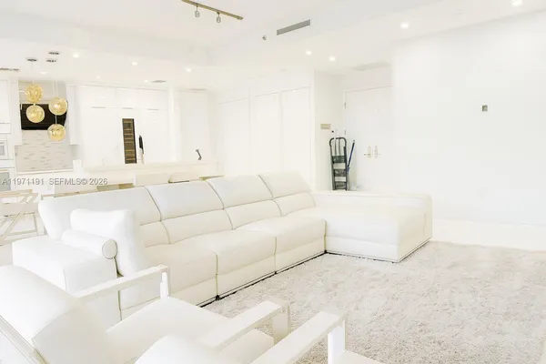 a living room with furniture and a lamp