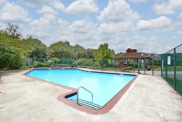 a view of a swimming pool with a yard