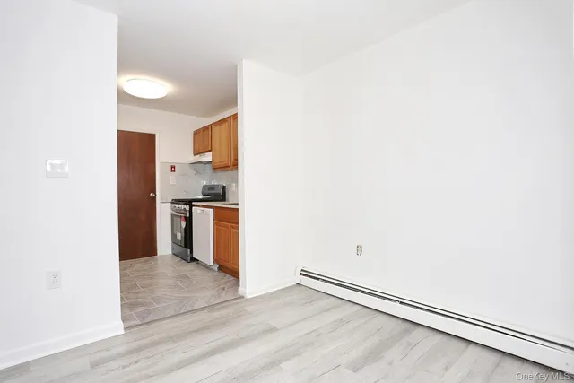 a kitchen with granite countertop white cabinets and stainless steel appliances