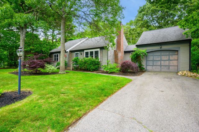 a view of a house with yard and a garden