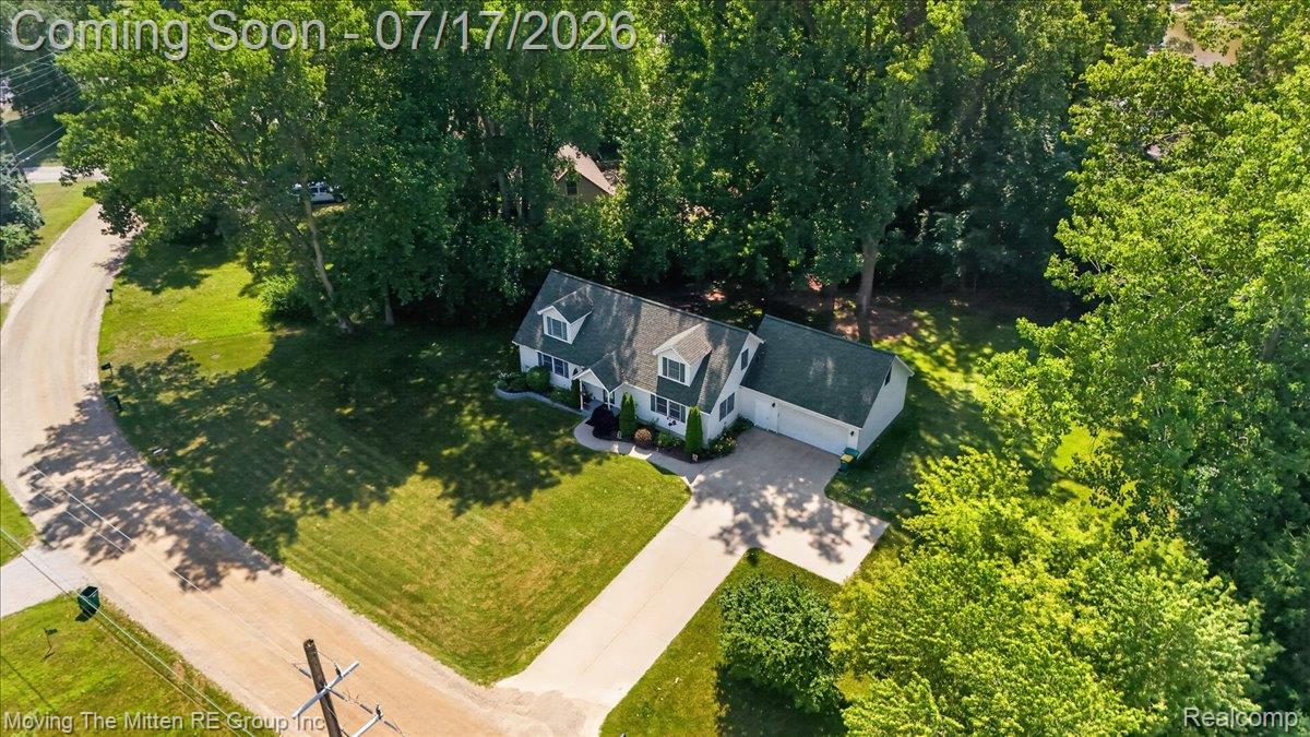 40162 Alden Road Belleville, MI 48111 - Photo 53 of 67 Aerial perspective showcasing a single-family residence with a green shingle roof and attached garage