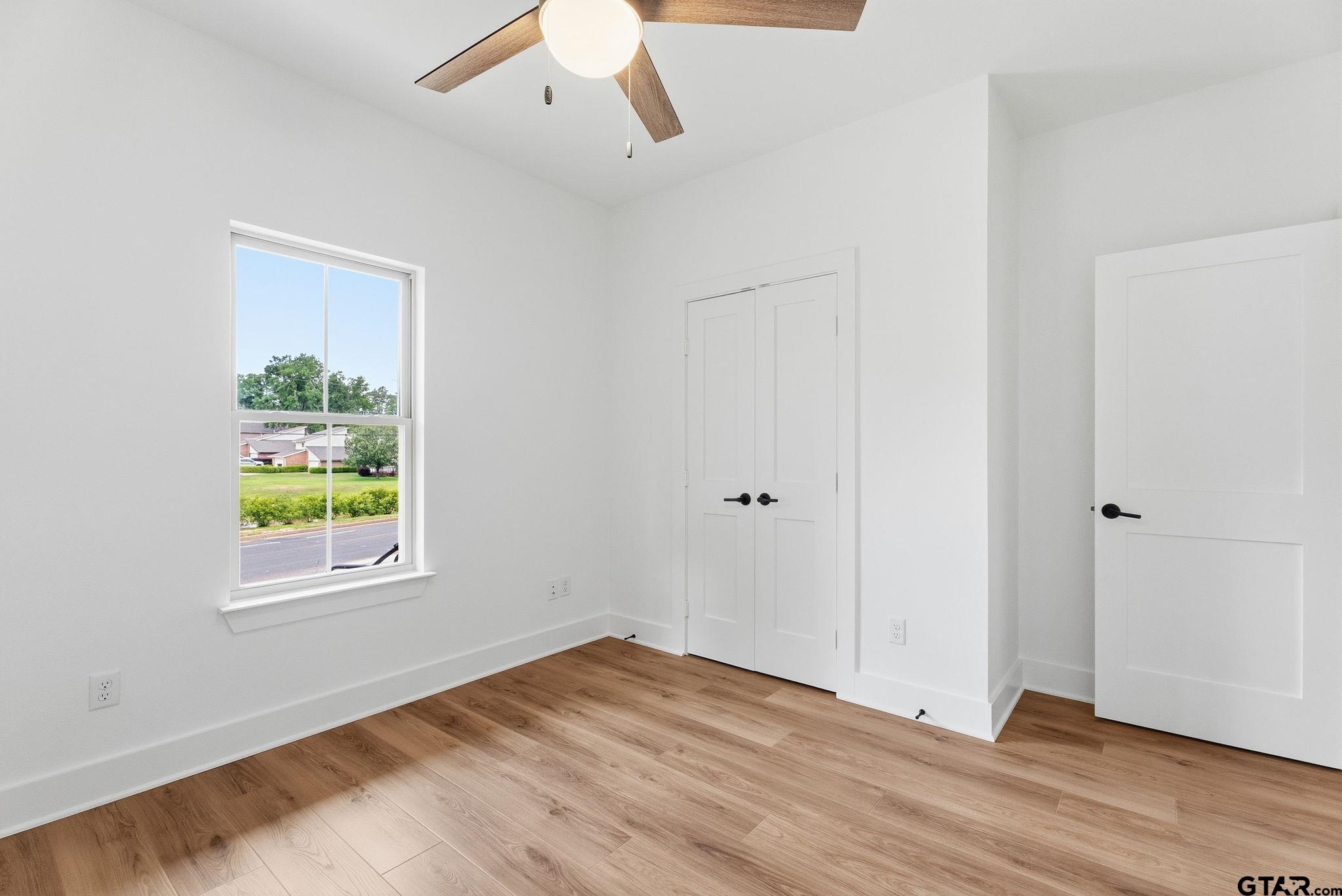 2968 Calloway Road Tyler, TX 75701 - Photo 14 of 24 a view of an empty room with wooden floor and window